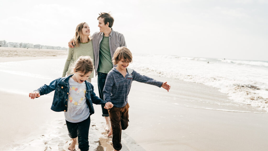 Family on beach. Income Protection Insurance: Safeguarding Your Financial Future